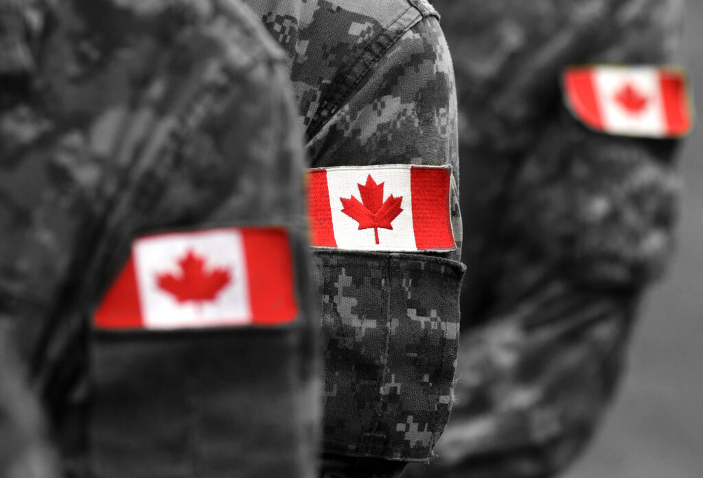 Canada flags on soldiers arm. Canadian troops